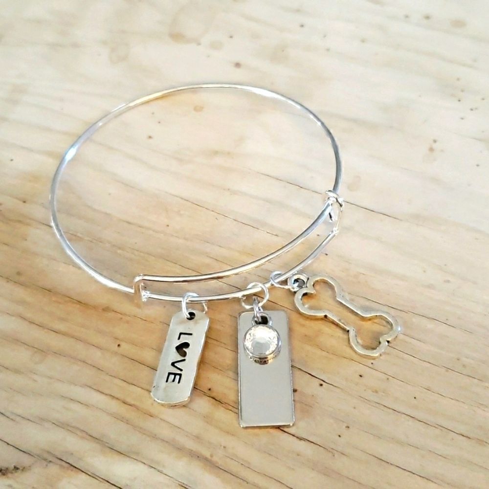 Bracelets by Sandra silver tone adjustable, dog bone